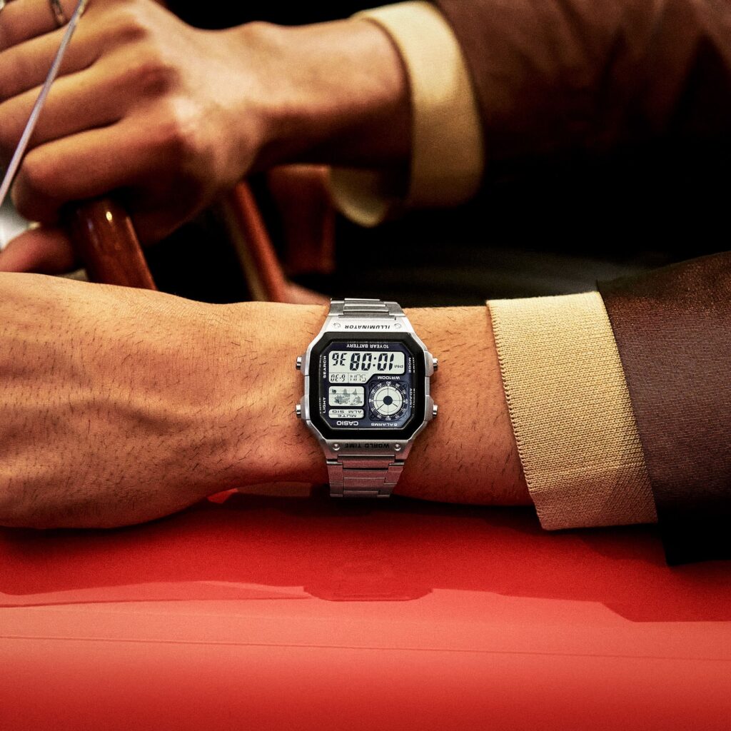 Casio AE-1200WHD silver bracelet digital watch worn on a wrist