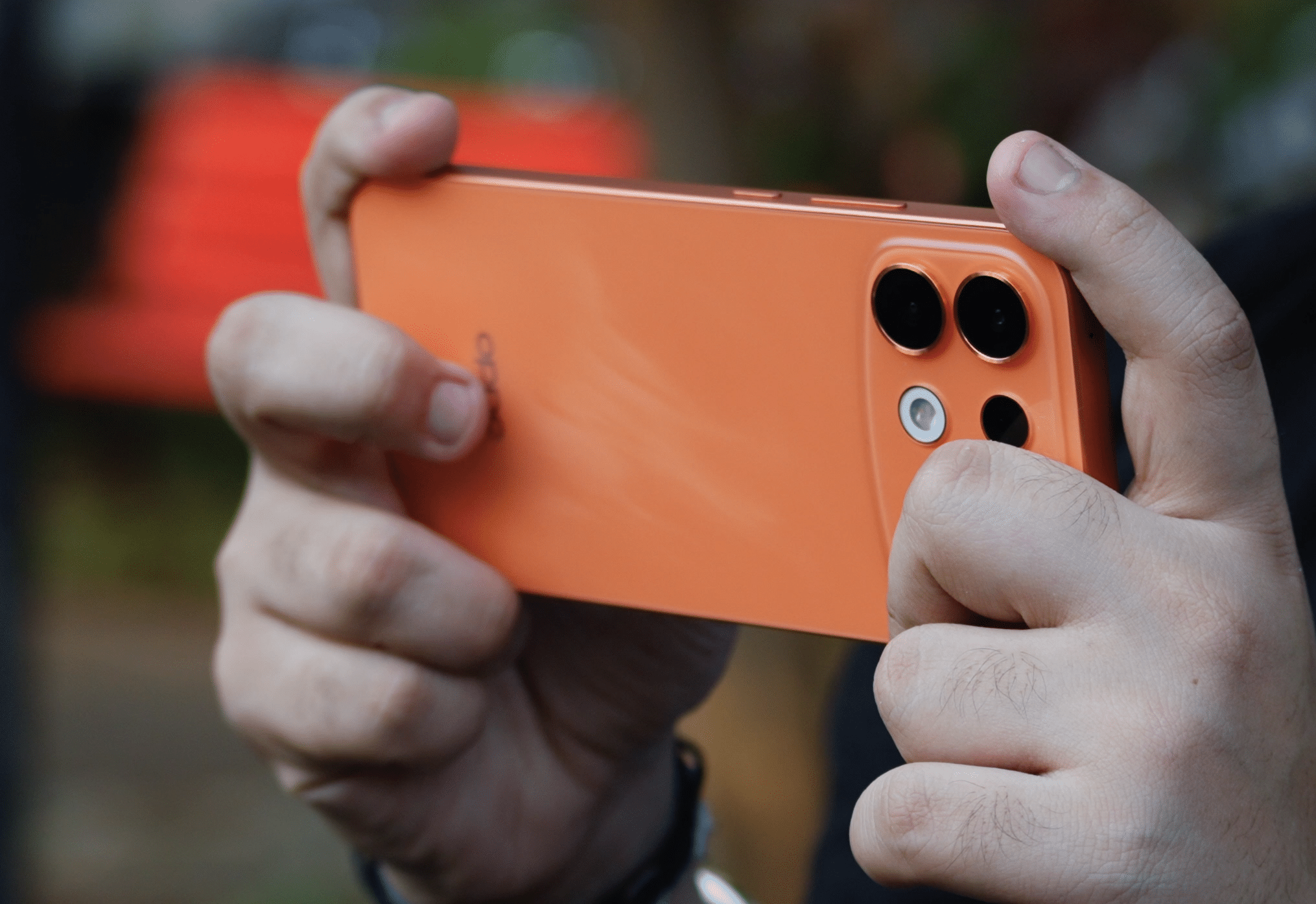 OPPO F35 Pro 5G Sunrise Orange phone held horizontally