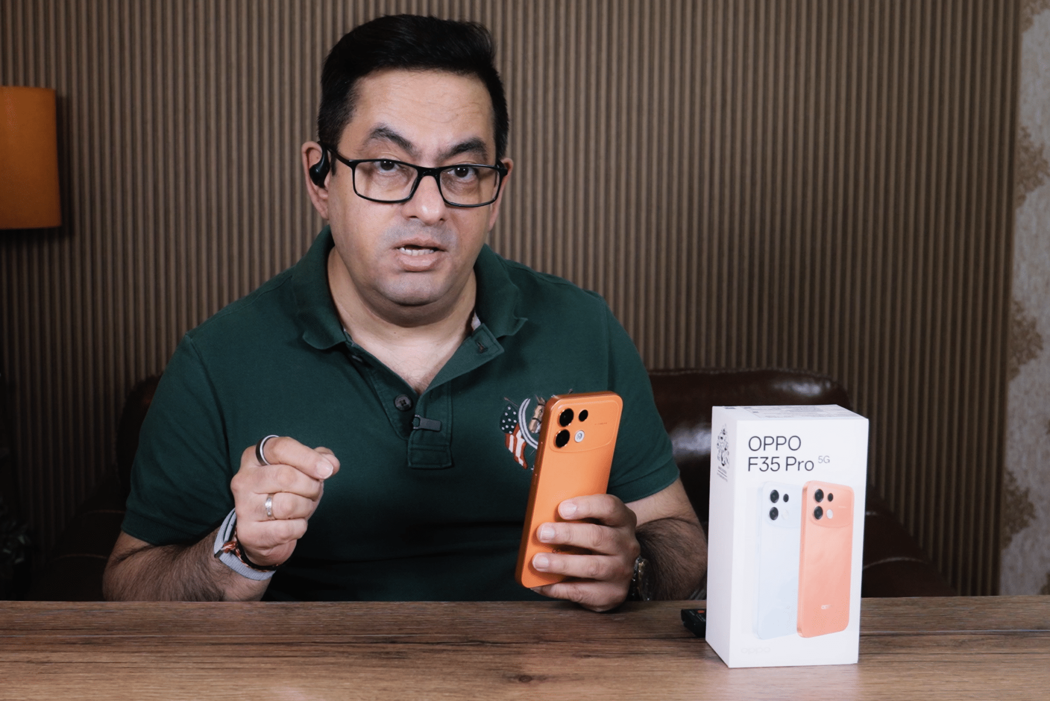 OPPO F35 Pro 5G orange rear design held in hand