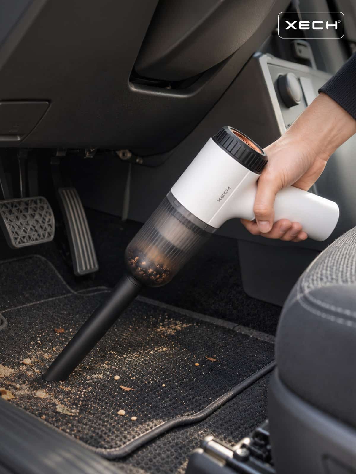 XECH V-GUN NEO cordless vacuum cleaning a car floor mat