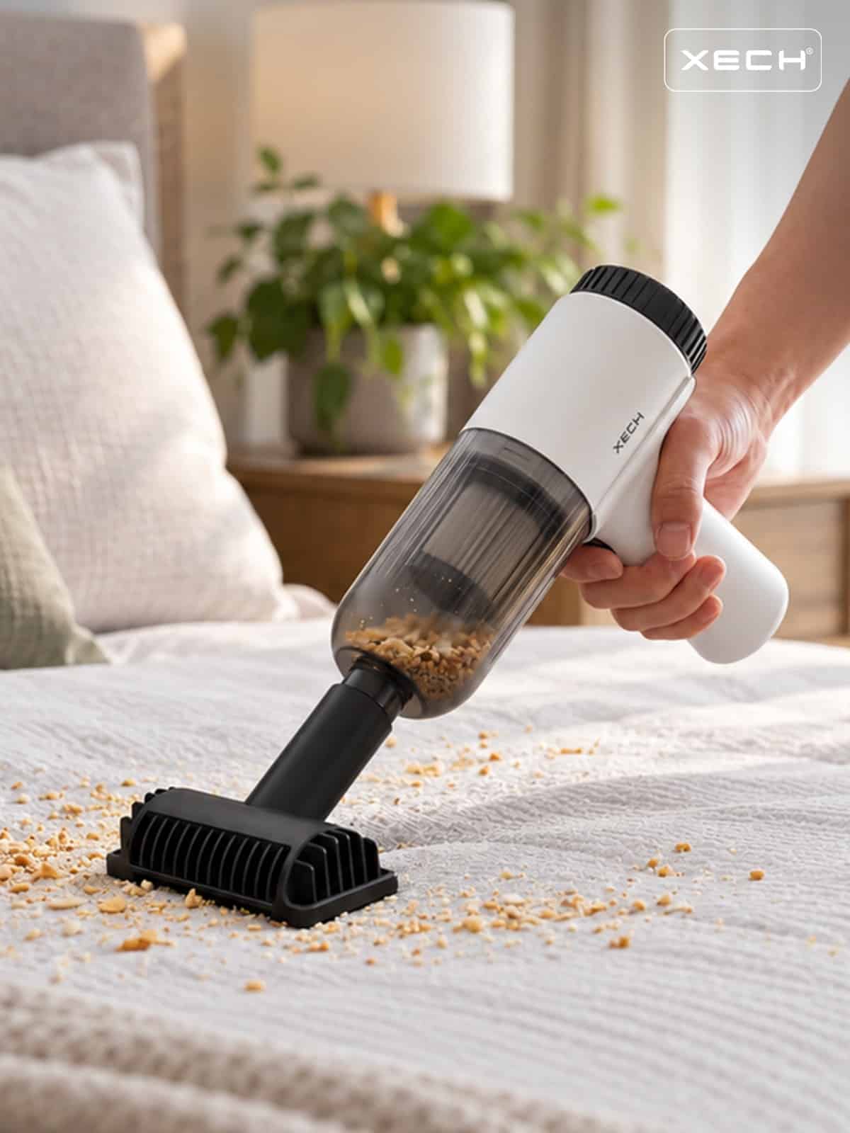 XECH V-GUN NEO with the wide brush attachment cleaning crumbs from upholstery